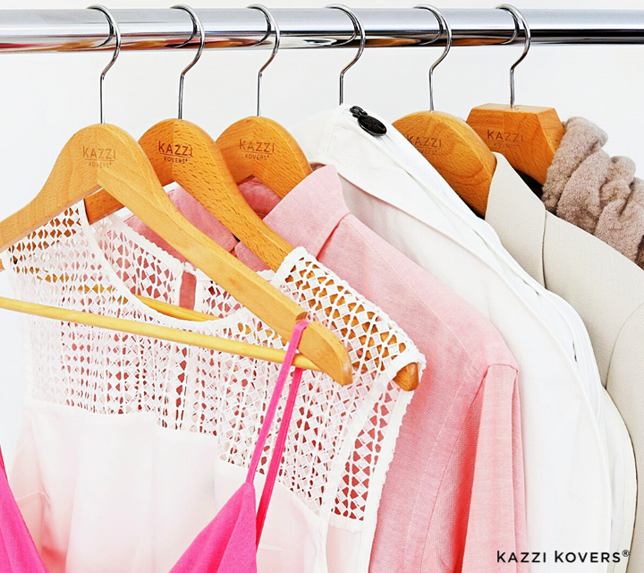 Organised garments in hues of pink with fully enclosed garment bag for moth protection