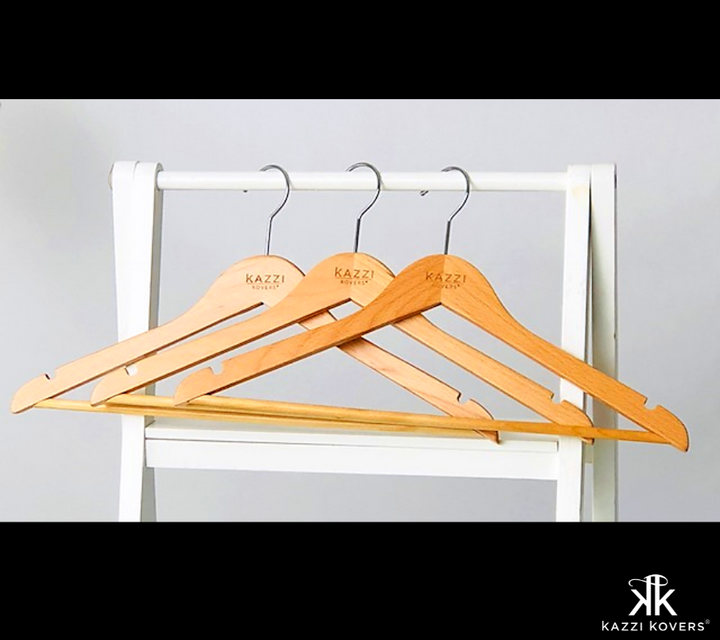 Stylish Kazzi Kovers natural wooden clothing hangers on white rod