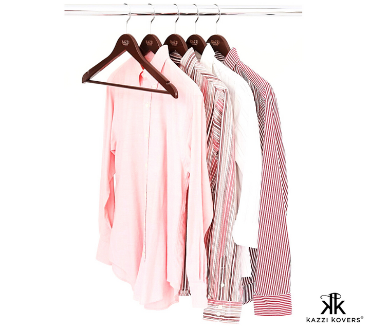 Long sleeved shirts organised on walnut wood hangers