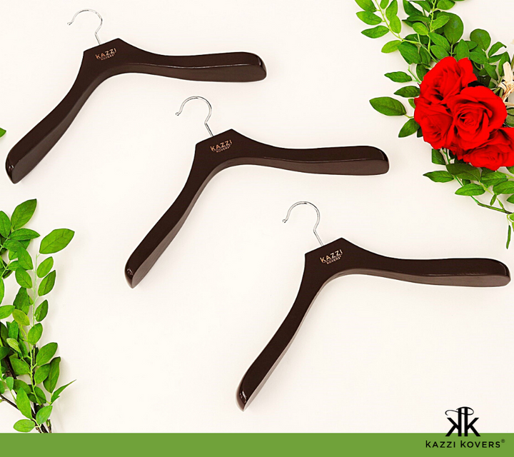 Walnut coat hangers with defined contoured 6 cm shoulders widths