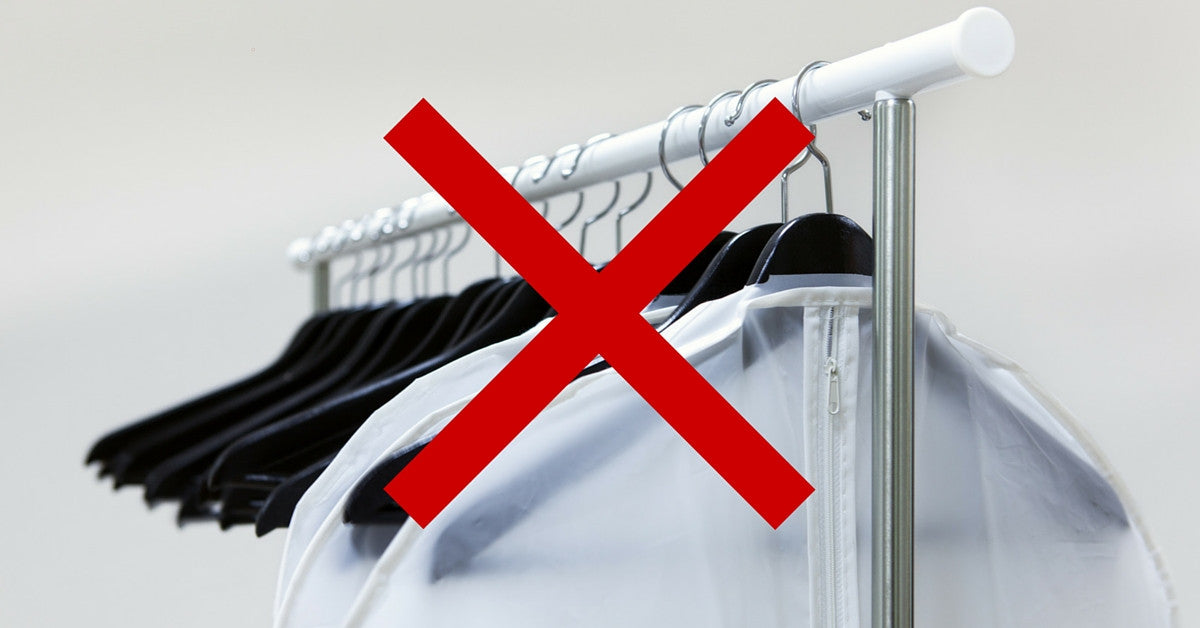 Plastic garment bags on clothes rack