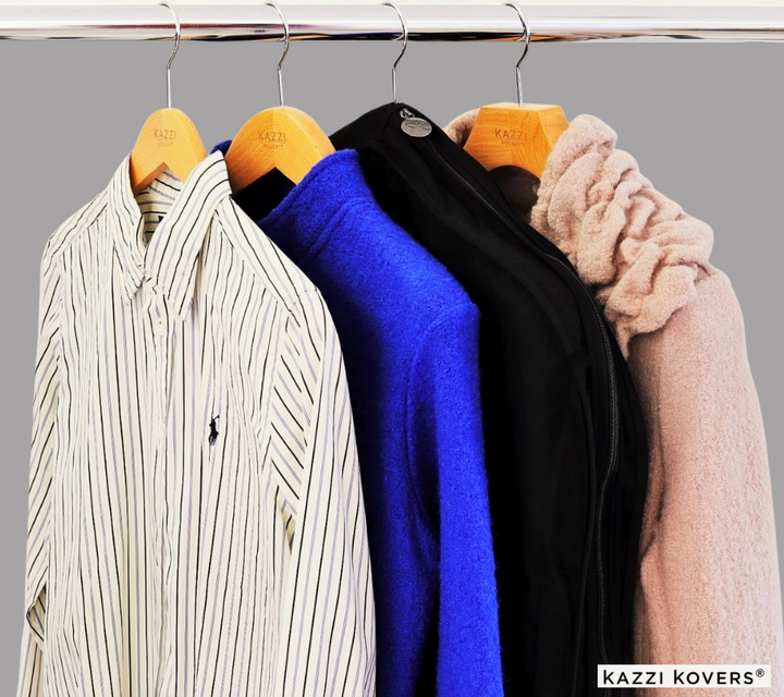 Black garment bag displayed with other clothing on a metal rack