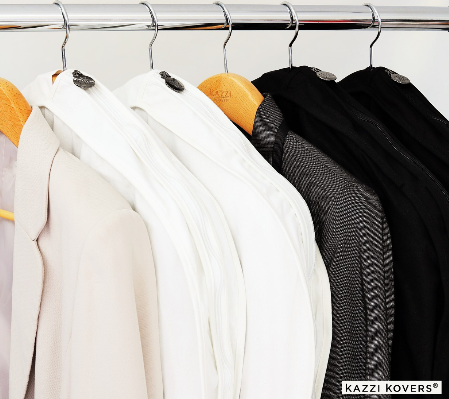 Timeless Cream and Black Garment Bags neatly organised and displayed on a wardrobe rack