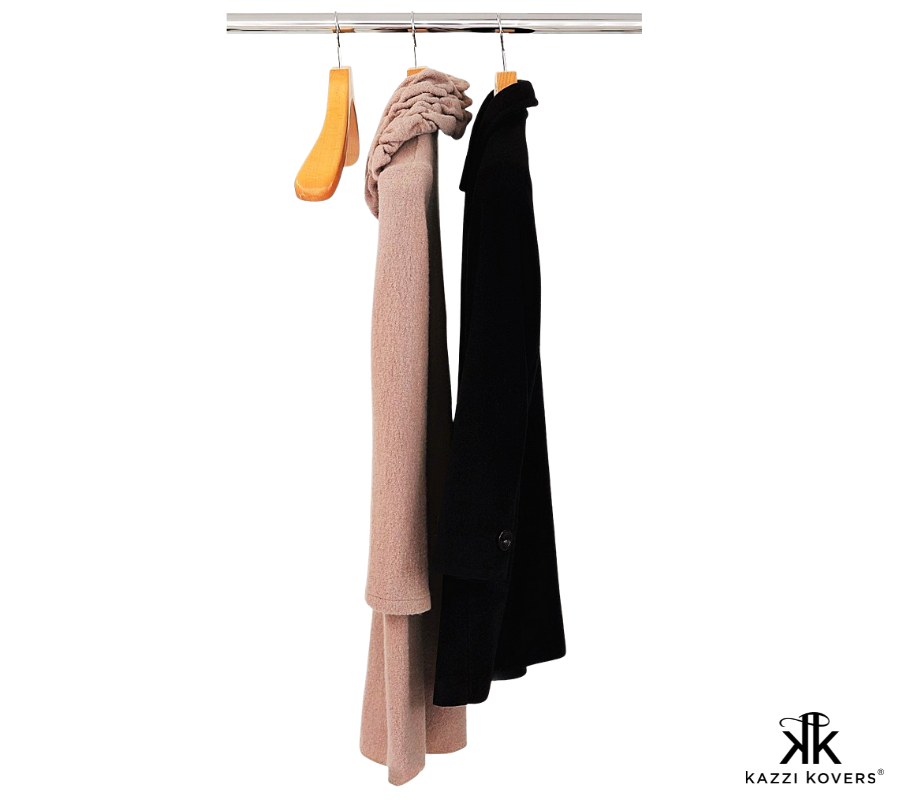 Heavy beige and black coats supported by wide shoulder coat hangers in natural wood grain | Kazzi Kovers