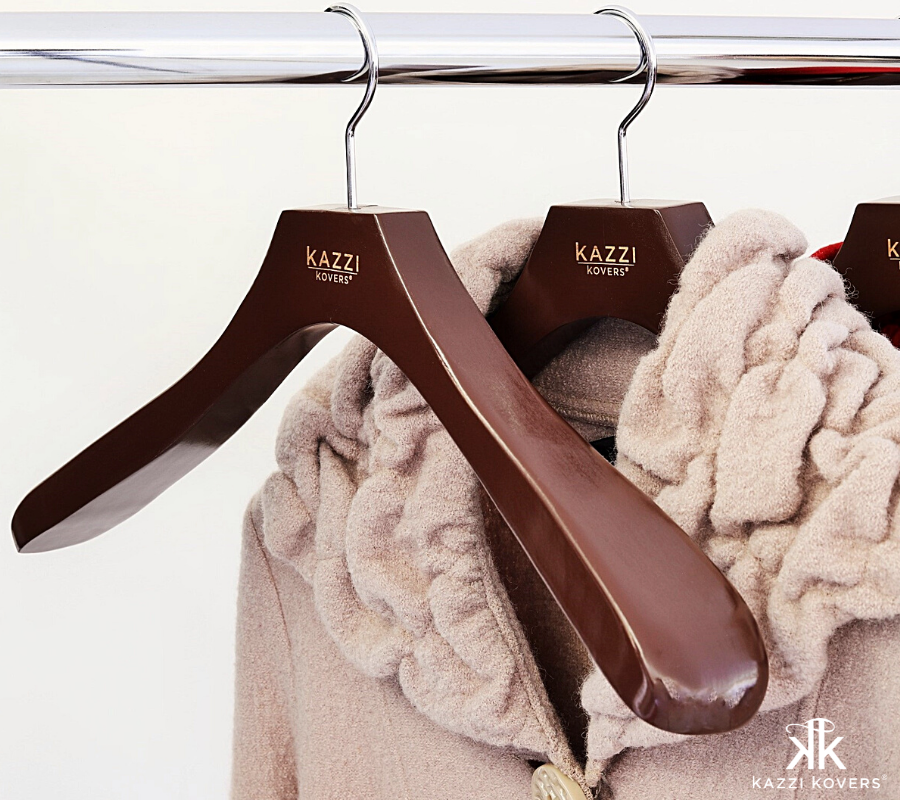 Thick wool beige coat hanging on Kazzi Kovers walnut coat hanger for extra garment support