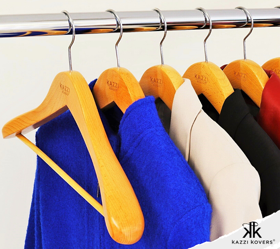 Kazzi Kovers natural wooden hangers with suits and jackets neatly organised on clothing rack