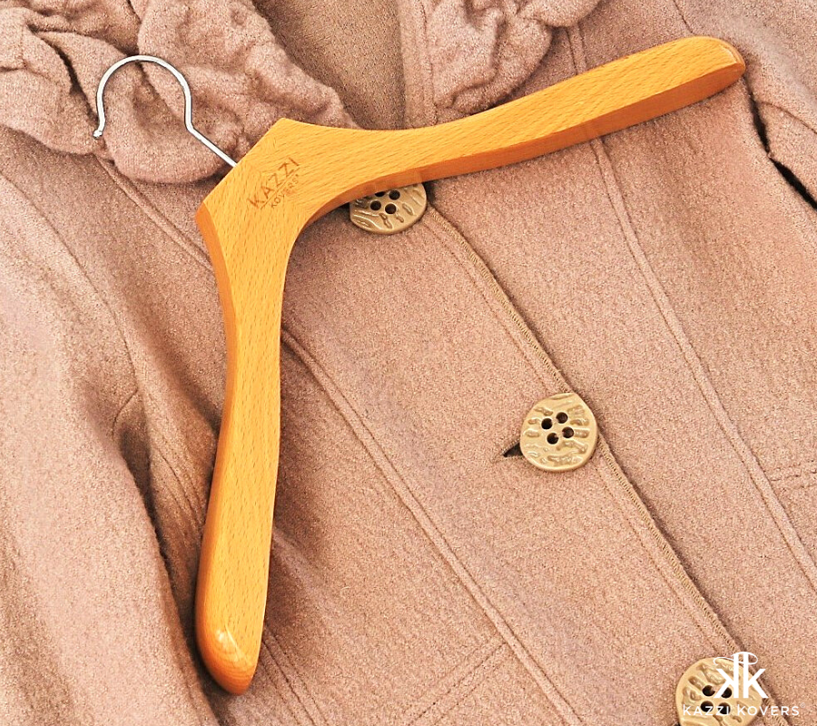 Kazzi Kovers wide shoulder wood hanger with beige coat