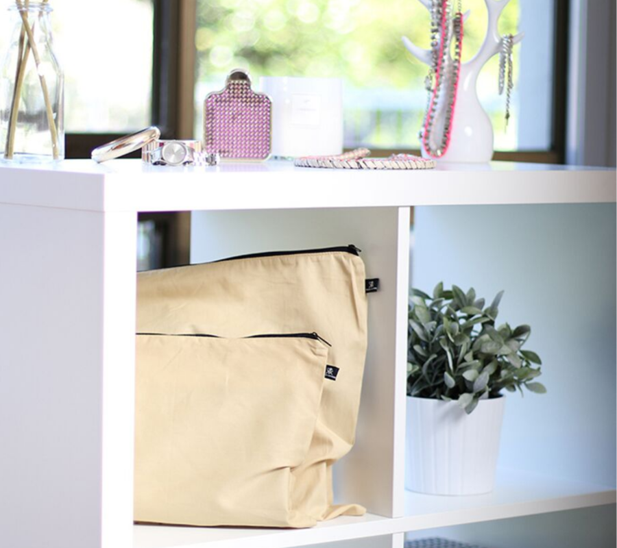 Large and medium beige cotton bags displayed on shelves