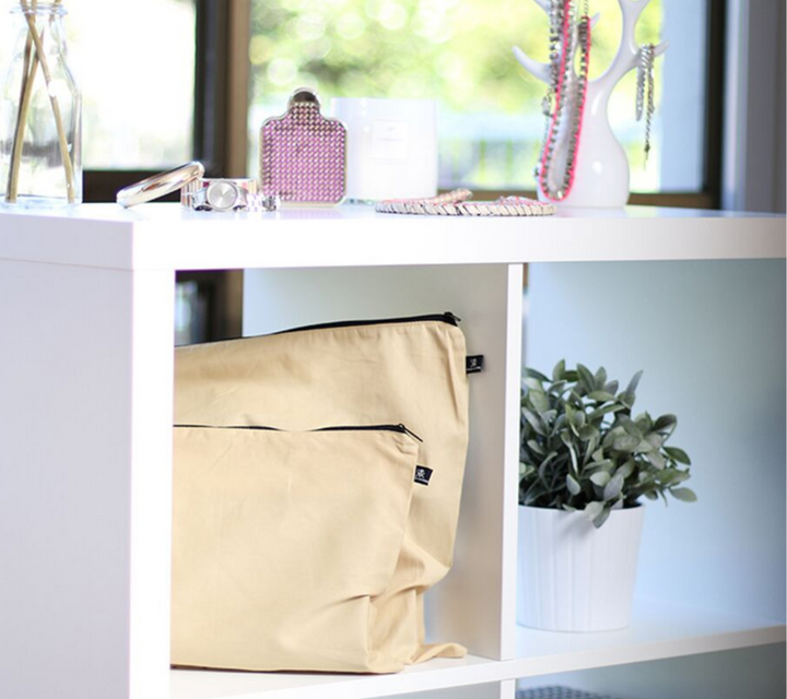 Large and medium beige cotton bags displayed on shelves