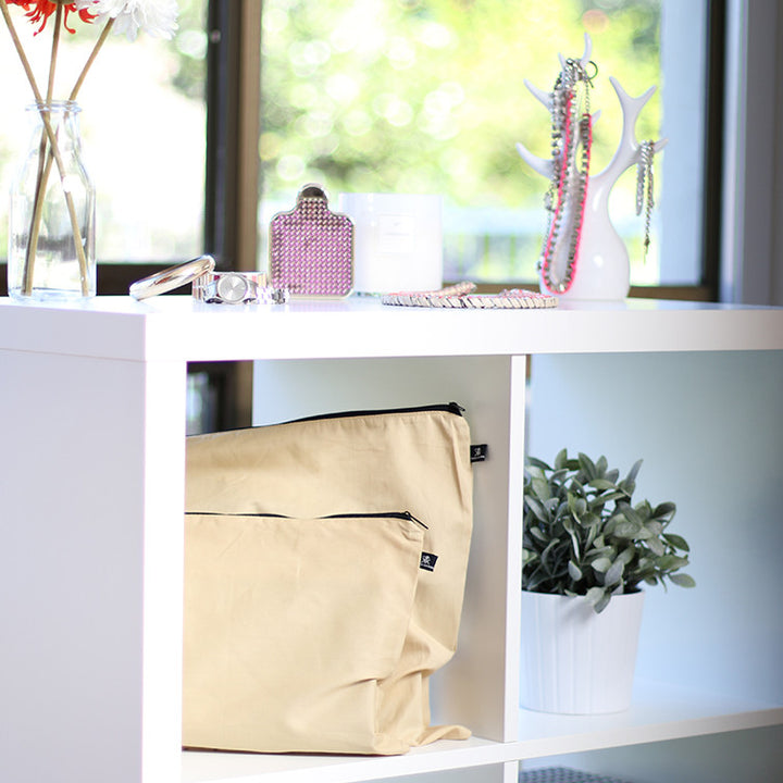 Organised handbags on shelf in beige covers