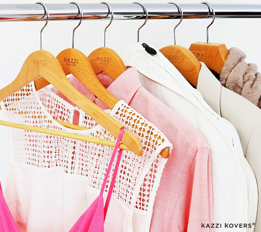 Organised garments in hues of pink with fully enclosed garment bag for moth protection 