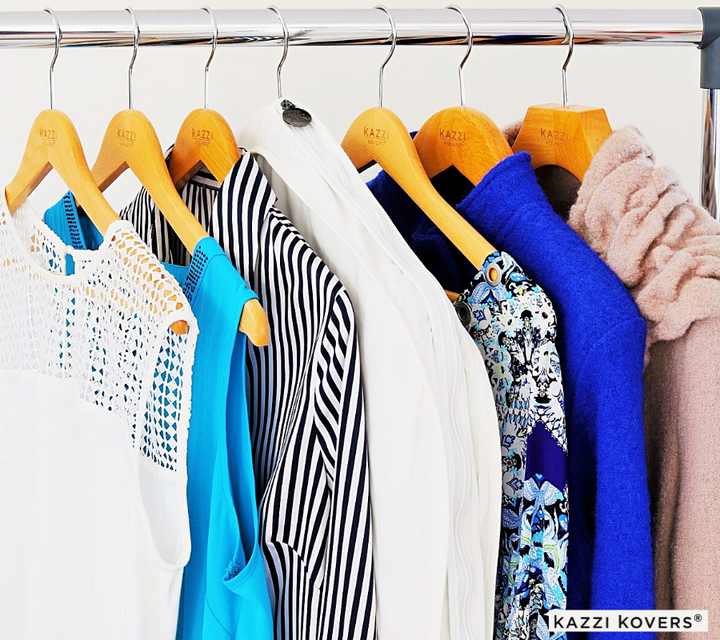 Cream garment bag displayed with various garments on rack