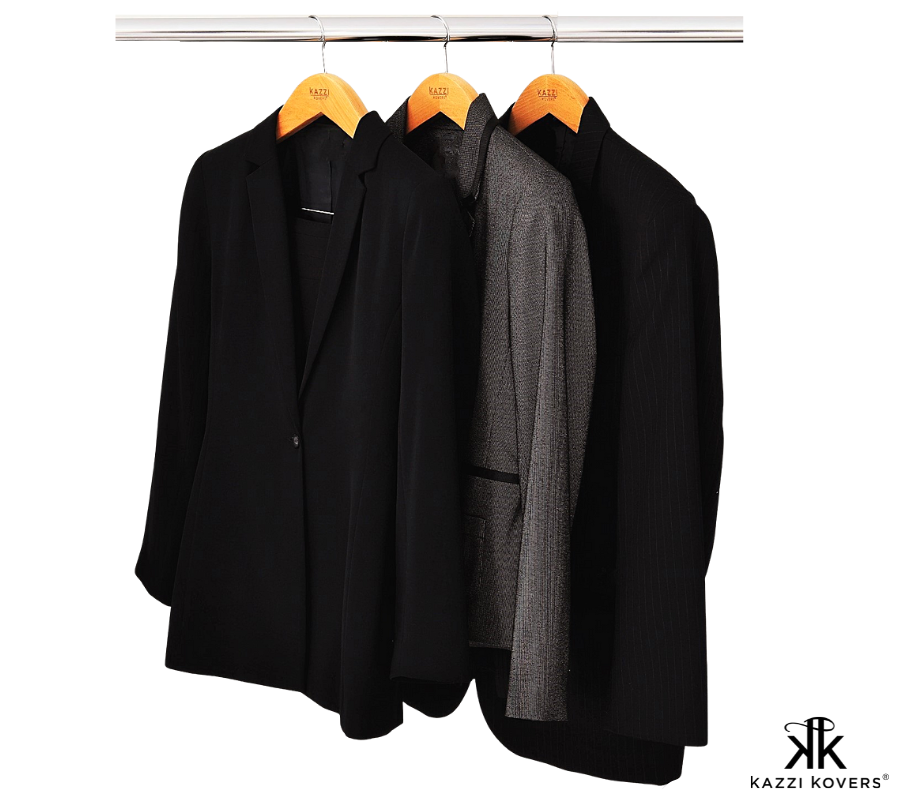 Black and grey suits displayed on wooden clip hangers