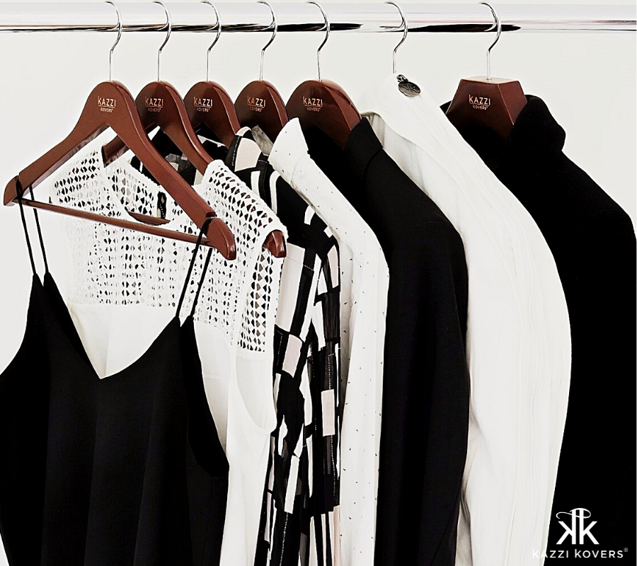 Various walnut hangers with black and white garments | Kazzi Kovers