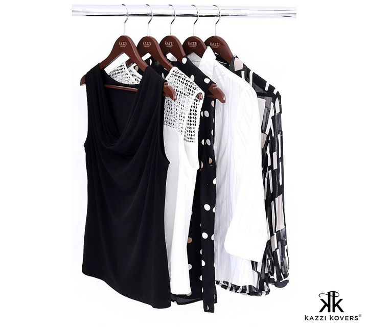 Black and white blouses and womens long sleeved shirts organised on wardrobe rail