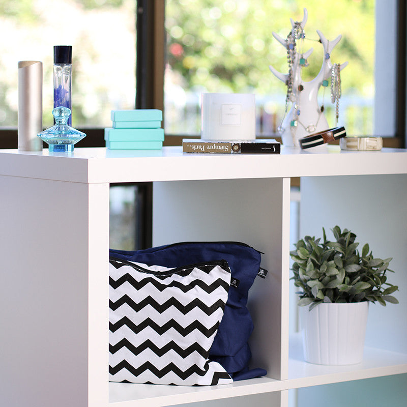 Blue and chevron handbag dust bags displayed on shelf