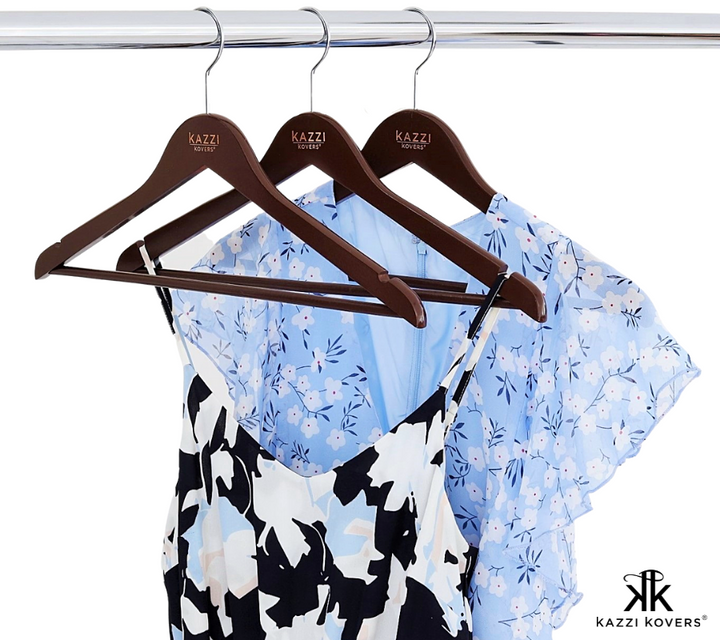 Blue and white garments displayed on walnut clothes hangers