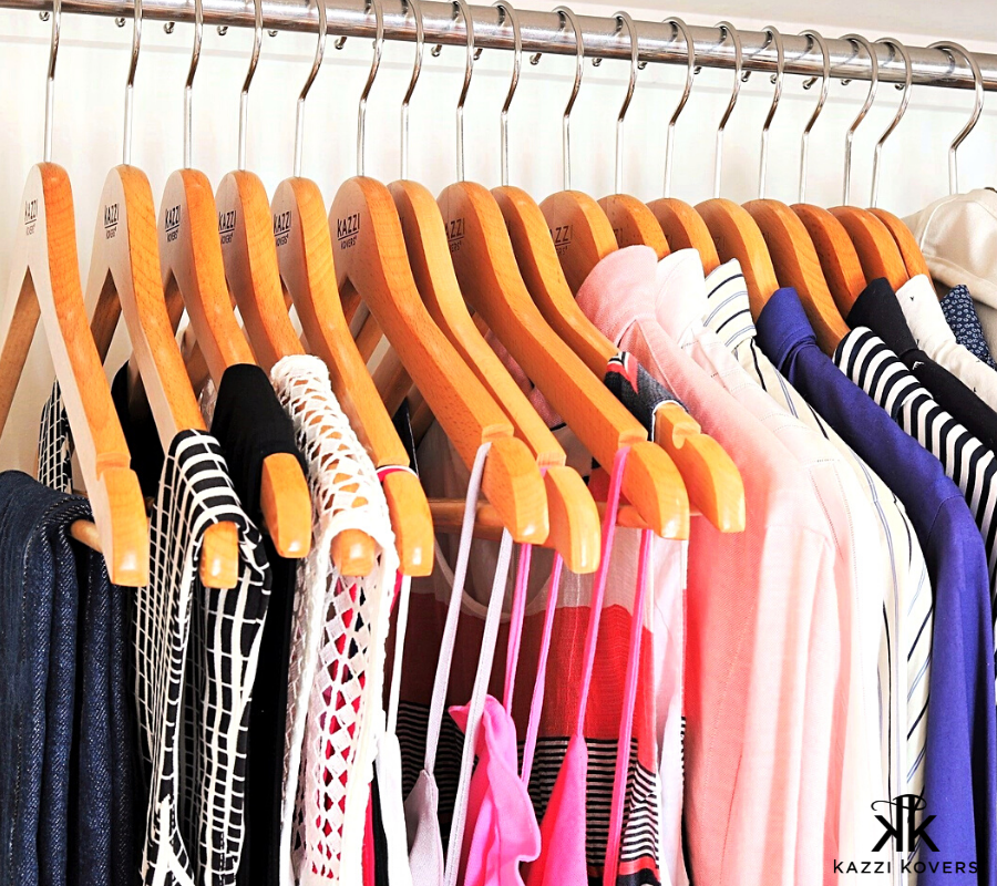 Bulk Kazzi Kovers clothes hangers neatly organised on wardrobe rail with various garments