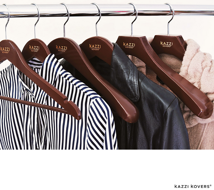 Walnut wooden hangers with shirt, jacket, and beige coat