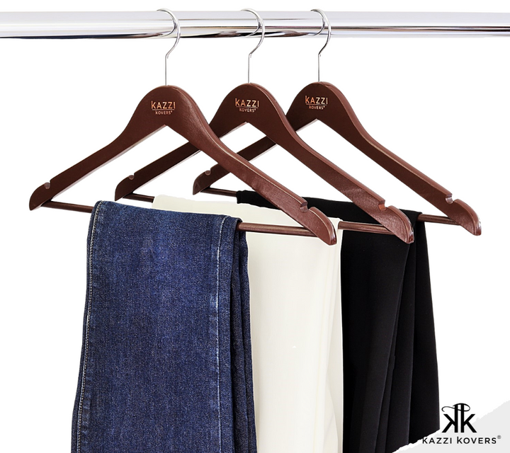 Jeans and pants neatly organised on walnut wood hangers