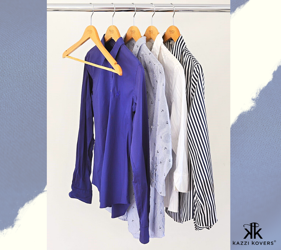 Long sleeved shirts in blue hues organised on Kazzi Kovers wooden clothes hangers