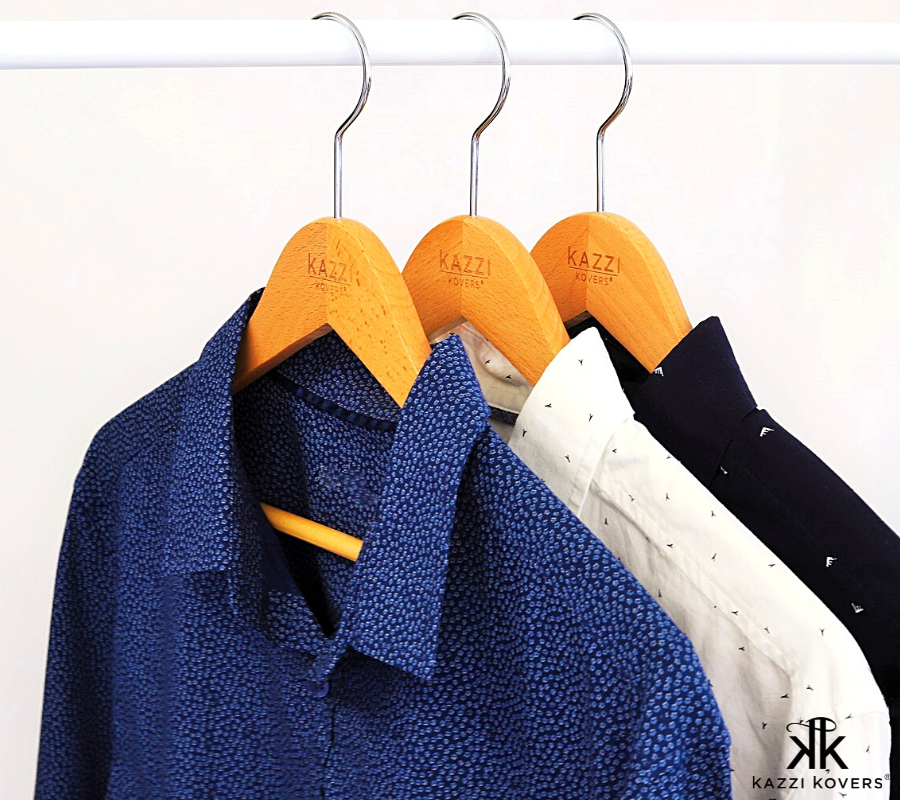 Mens buttoned shirts on wooden hangers