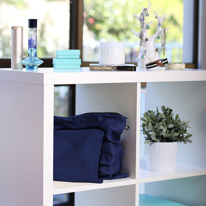 Midnight Blue handbag dust bags displayed on shelf