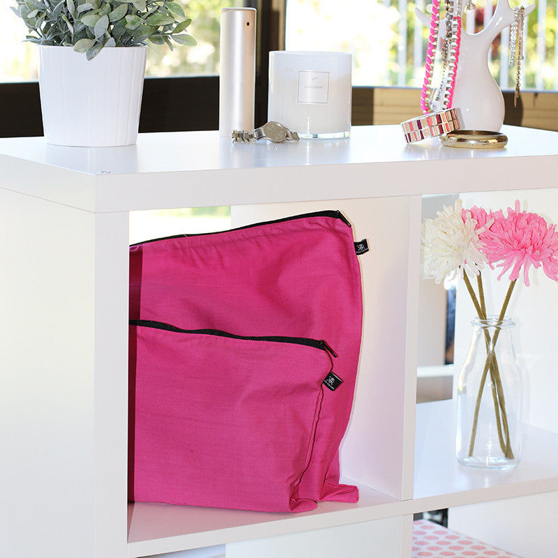 Pink handbag dust bag displayed on shelf