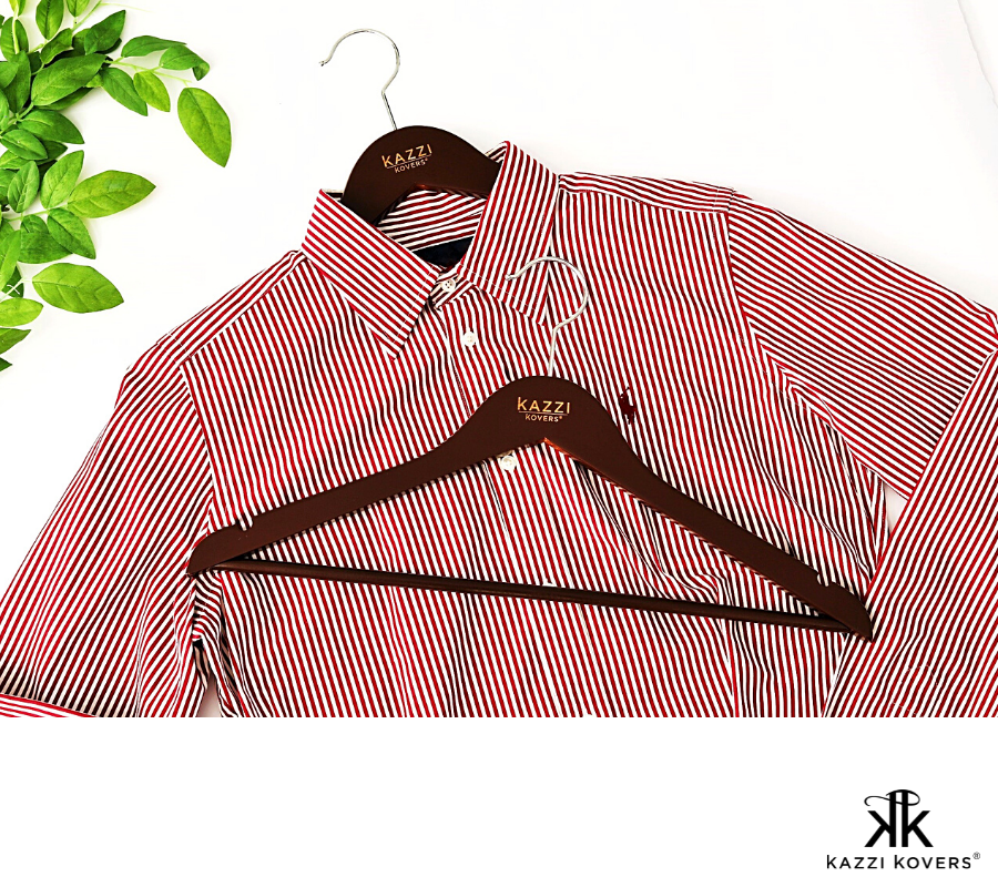 Striped red and white buttoned shirt displayed with walnut hangers