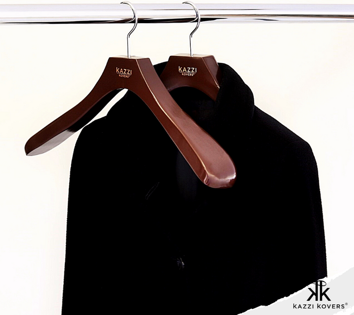 Black coat with wide coat hangers for extra shoulder support and garment care